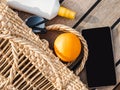 Ripe oranges, wicker basket, sunblock and sunglasses