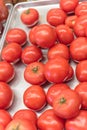 Ripe organic beefsteak tomatoes on metal tray at local market in Texas, America