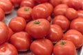 Ripe organic beefsteak tomatoes on metal tray at local market in Texas, America