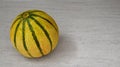 Ripe organic cantaloupe melon or muskmelon,mushmelon, rockmelon on a gray stone background.