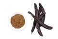 Ripe organic carob fruit pods and powder from locust beans on white background. Healthy alternative to cocoa and sugar Royalty Free Stock Photo