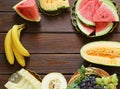 Ripe organic fruit watermelon, melon cantaloupe and grapes on a wooden table Royalty Free Stock Photo