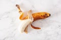 Ripe overripe organic banana on marble background. ugly food zero waste concept