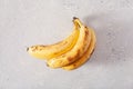 Ripe overripe organic bananas on concrete background. ugly food zero waste concept