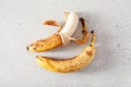 Ripe overripe organic bananas on concrete background. ugly food zero waste concept