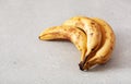 Ripe overripe organic bananas on concrete background. ugly food zero waste concept