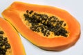 ripe papaya fruit cut in half with seeds isolated on white background. Royalty Free Stock Photo