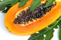 Ripe papaya with seeds and leaf