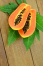 Ripe papaya on wood background.