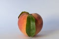 A ripe peach on white background with one leaf Royalty Free Stock Photo