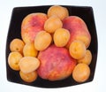 Ripe peaches and apricots in black plate Royalty Free Stock Photo
