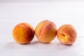 Ripe peaches close-up on a white wooden background Royalty Free Stock Photo