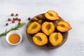 Ripe peaches, pitted halves, hazelnuts, honey and rosemary on light gray background, top view. Cooking delicious dessert Royalty Free Stock Photo