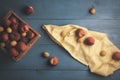 Ripe peaches in a wooden box on a blue table. Fresh fruits