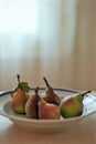 Ripe pears in a deep plate on the table Royalty Free Stock Photo