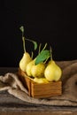 Ripe pears in a wooden box on the table. Fresh ripe organic pears on rustic wooden table, natural background, vega, diet food. Royalty Free Stock Photo