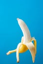 Ripe Peeled Banana Floating Levitating in the Air on Blue Background. Vitamins Healthy Diet Energy Summer Detox Vegan Super foods