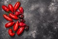 Ripe pepperlike heirloom tomatoes atop dark textured backdrop, copy spce, top view Solanum lycopersicum fruits Royalty Free Stock Photo