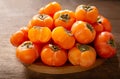 Ripe persimmon fruit on a wooden board Royalty Free Stock Photo