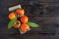 Ripe persimmon with leaves flowers. ruit containing vitamins, trace elements, macronutrients.