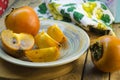 Ripe persimmon on a plate