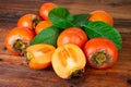 Ripe persimmons kaki fruits on rustic background