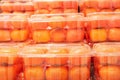Ripe persimmons in plastic containers close-up in a supermarket. Royalty Free Stock Photo