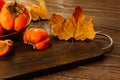 Ripe persimmons on a wooden background. Persimmon variety Fuyu