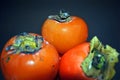 Ripe persimons on dark background Royalty Free Stock Photo
