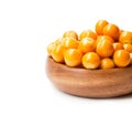 Ripe physalis in wooden bowl on white background Royalty Free Stock Photo