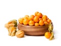 Ripe physalis in wooden bowl on white background Royalty Free Stock Photo