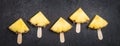 Ripe Pineapple slices on sticks on a black background Royalty Free Stock Photo