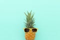 Ripe pineapple in stylish sunglasses over wooden blue background. Tropical summer vacation concept. top vew Royalty Free Stock Photo
