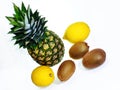 A ripe pineapple with two lemons and three kiwi fruits on white background top view Royalty Free Stock Photo