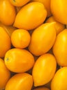 Ripe plum yellow tomatoes as a background