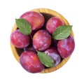 Ripe plums and leaves in a bowl isolated on white background. Top view. File contains clipping path Royalty Free Stock Photo