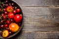 Ripe plums, nectarines and cherries in rustic pan Royalty Free Stock Photo