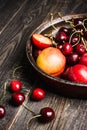 Ripe plums, nectarines and cherries in rustic pan Royalty Free Stock Photo