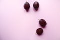 Ripe plums on a pastel background, arranged randomly, top view, close-up