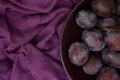 Ripe plums on a plate - dark purple composition Royalty Free Stock Photo
