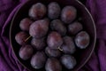 Ripe plums on a plate - dark purple composition Royalty Free Stock Photo