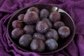 Ripe plums on a plate - dark purple composition Royalty Free Stock Photo