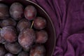 Ripe plums on a plate - dark purple composition Royalty Free Stock Photo