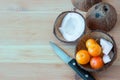 Ripe plums and slices of coconut in the bowl from coconut shell.