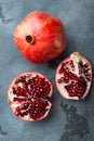 Ripe pomegranate with fresh juicy seeds, on grey background, top view