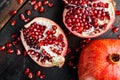 Ripe pomegranate with fresh juicy seeds, on old wooden table, top view