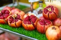 Ripe pomegranate fruit cut on the table of a street fruit vendor Royalty Free Stock Photo
