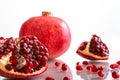 Ripe pomegranate berries on a white background