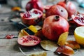 Ripe pomegranate fruit on wooden vintage background. Red juice p Royalty Free Stock Photo