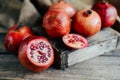 Ripe pomegranate fruit on wooden vintage background. Red juice p Royalty Free Stock Photo